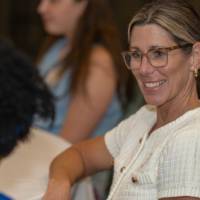 A guest smile while seated at a table